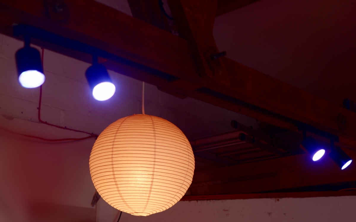 Paper globe lamp and blue spots on the beams